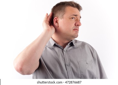 Senior Man Cupping Hand Behind Ear Trying To Hear