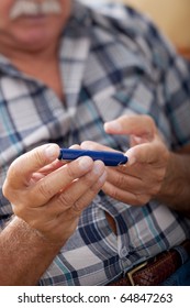 Senior Man Doing Blood Sugar Test At Home