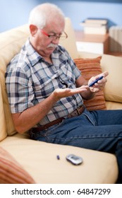 Senior Man Doing Blood Sugar Test At Home