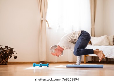 Senior man doing exercise at home.