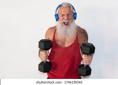 Senior Man Doing Gym Workout With Dumbbells While Wearing Face Protective Mask During Coronavirus Isolation Quarantine - Fitness, Sport And Healthy Elderly Lifestyle - Focus On Face