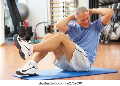 Senior Man Doing Sit Ups In Gym