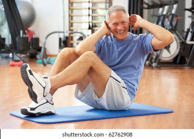 Senior Man Doing Sit Ups In Gym