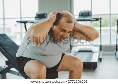 Senior Man Doing Situps on Bench in Gym