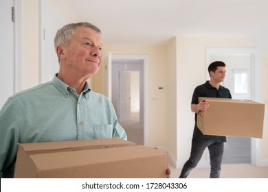  Senior Man Downsizing In Retirement Carrying Boxes Into New Home On Moving Day With Removal Man Helping - Powered by Shutterstock