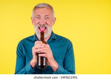 Senior Man Drinking Alcohol Alone Studio Yellow Baclground.