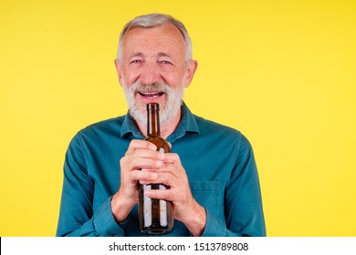 Senior Man Drinking Alcohol Alone Studio Yellow Baclground