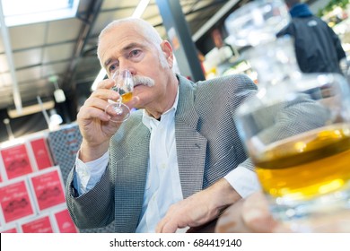 Senior Man Drinking Alcohol Alone