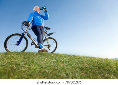 Senior Man Drinking Water On Bike Ride