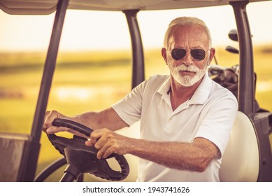 Senior Man Driving Golf Car. 