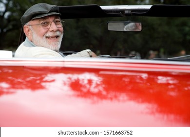 A Senior Man Driving A Sports Car