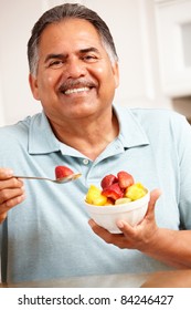Senior man eating fruit