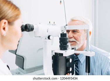Senior man examined by an ophthalmologist, eye exam