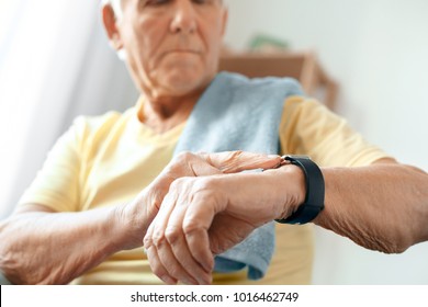 Senior Man Exercise At Home Health Care Measure Pulse