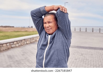 Senior man, exercise and stretching arms at promenade beach for fitness, wellness or training. Male warm up body outdoor for workout, sports performance and start healthy cardio marathon of mobility - Powered by Shutterstock