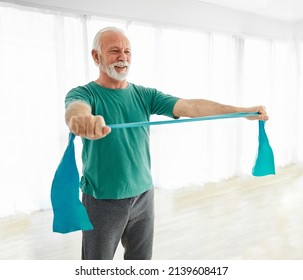 Senior man exercise stretching and exercising with resistance band at home orin a clinic or physiotherapy - Powered by Shutterstock