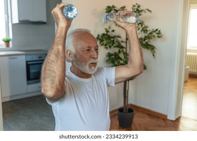 Senior man exercises with water bottles sitting on a fitness ball at home during the day, home workout concept. - Powered by Shutterstock