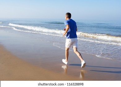 Senior Man Exercising On Beach