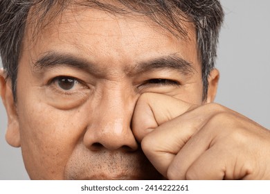 Senior man eye strain after for long stretches at computer or digital screens. - Powered by Shutterstock