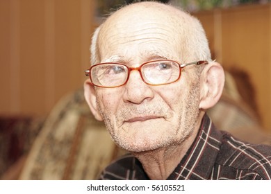 Senior Man In Eyeglasses Looking To Camera Indoor Portrait