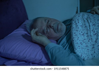 Senior man fall asleep in the bed during midnight