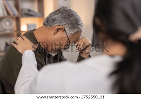 Senior man feeling stressed while caregiver offers emotional support during home healthcare visit. Elderly mental health, compassion, caregiver assistance and senior wellbeing concept.