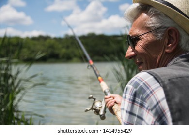 Senior Man Fishing By A Lake