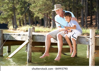 Senior Man Fishing With Grandson