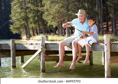 Senior Man Fishing With Grandson