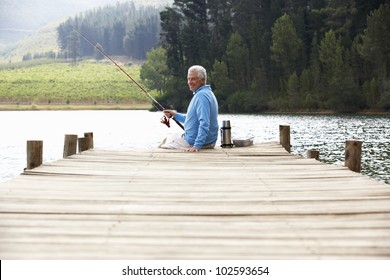 Senior Man Fishing On Jetty