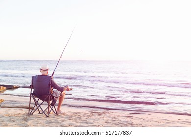 Senior Man Fishing At Sea Side