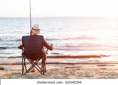 Senior Man Fishing At Sea Side