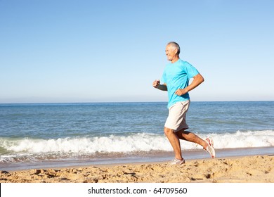 Senior Man In Fitness Clothing Running Along Beach - Powered by Shutterstock