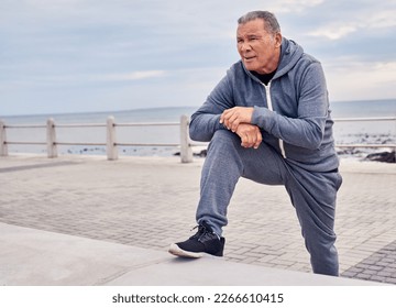 Senior man, fitness and stretching at beach sidewalk for energy, wellness and healthy cardio workout. Elderly male, exercise and rest at seaside promenade for training, sports and breathing outdoor - Powered by Shutterstock