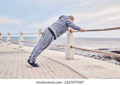 Senior man, fitness and stretching at beach sidewalk for energy, wellness and healthy cardio workout. Elderly male, warm up and exercise at seaside promenade for training, sports and body performance - Powered by Shutterstock