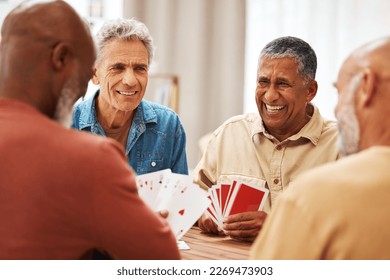 Senior man, friends and laughing for card games on wooden table in fun activity, social bonding or gathering. Group of happy elderly men with cards for poker game enjoying play time together at home - Powered by Shutterstock