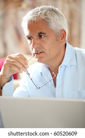 Senior Man In Front Of Laptop Computer