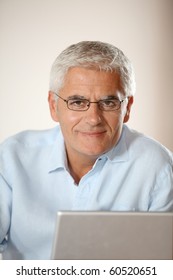 Senior Man In Front Of Laptop Computer