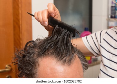 Senior Man Getting A Haircut At Home