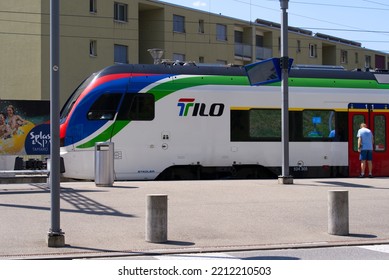 Senior Man Getting On Tilo Train At Railway Station Tenero, Canton Ticino, On A Sunny Summer Day. Photo Taken July 26th, 2022, Tenero, Switzerland.