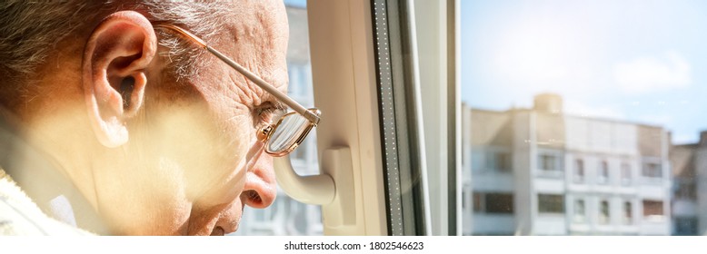 senior man in glasses looks through plastic window with open vent at city buildings under blue sky closeup - Powered by Shutterstock