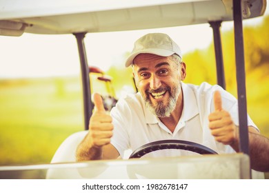 Senior Man In Golf Car With Thumbs Up.