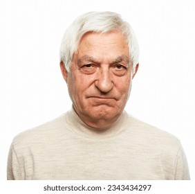 Senior man with gray hair frowns and looks displeased over white background. Close up. - Shutterstock ID 2343434297