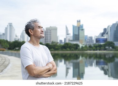 Senior Man With Grey Hair And Beard Standing And Taking A Deep Breath After Workout Near The Pond In Nature Atmosphere At The City Park,concept For Elderly People Lifestyle,health Care,well Being