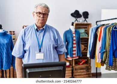 Senior man with grey hair working as manager at retail boutique depressed and worry for distress, crying angry and afraid. sad expression. 
