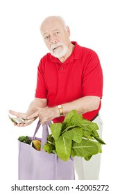 Senior Man Grocery Shopping,  Shocked At The High Cost Of Food.  Isolated On White.