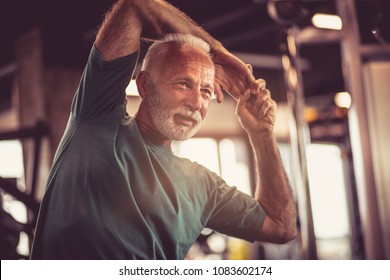 Senior Man At Gym Working Exercise.