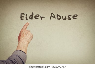 Senior Man Hand Pointing At Text With The Phrase Elder Abuse. Room For Text
