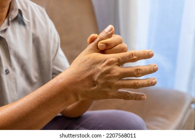 Senior Man Hand Suffering From Joint Pain With Gout Inflammation