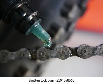 Senior Man Hands Spraying An Oil To Chain From The Wheel Bike, Doing Maintenance